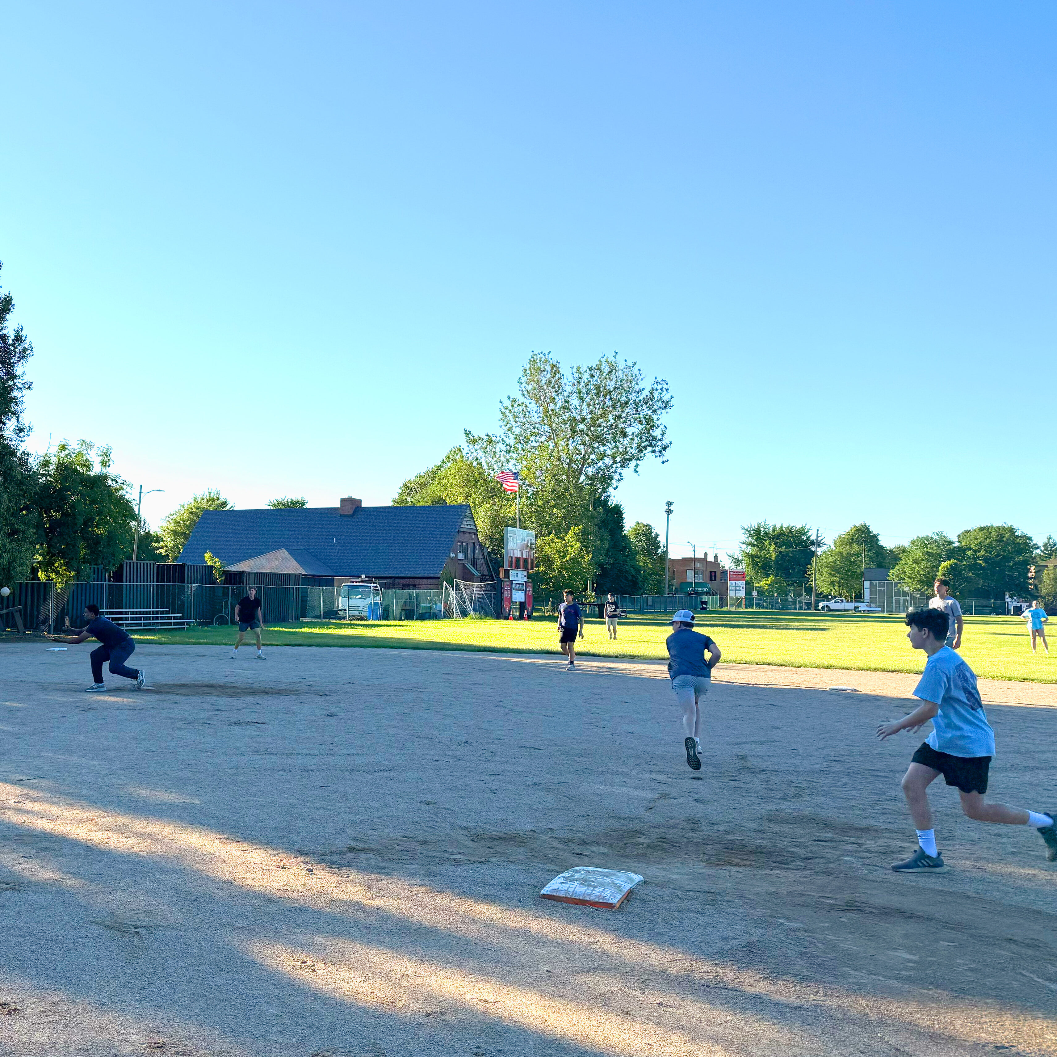 Bases on a diamond are filled by youths particpating in summer softball.