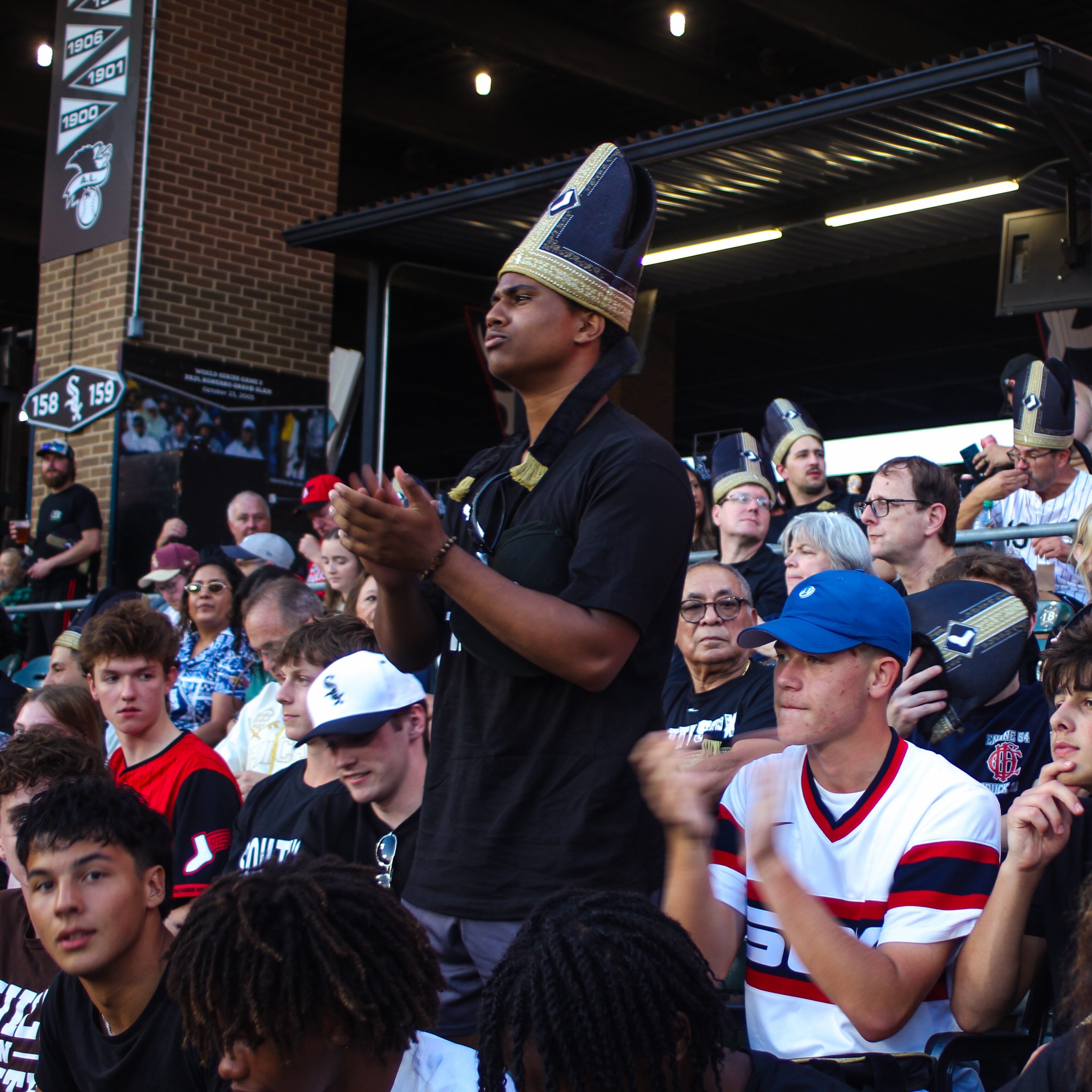 Teens applauding in the stands of Rate Field at a White Sox game